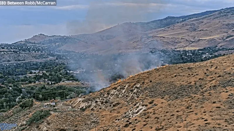 Fire burns near I-80 and McCarran Blvd. in Reno, smoke visible from freeway