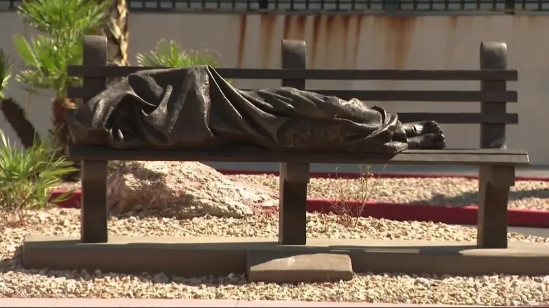 Bronze "Homeless Jesus" statue on bench near the Strip sparks homelessness awareness