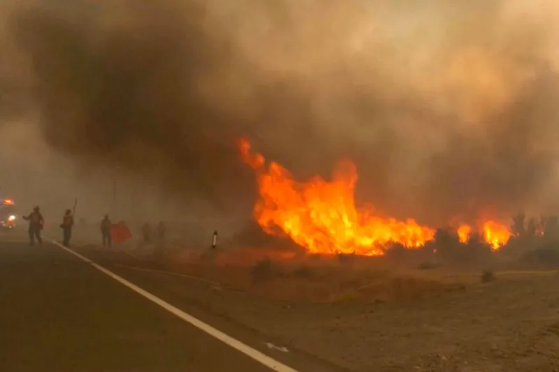 Firefighters are trying to stop a fast-moving wildfire from spreading to homes in Reno