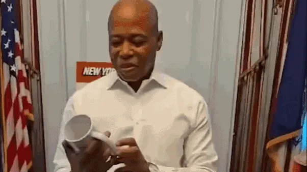 Adams reads his 'greatest hits' quotes from coffee mug in farewell tribute as NYC mayor