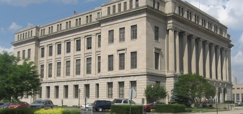 A Scioto County commissioner and his wife plead guilty to charges in a kickback scheme involving a business park