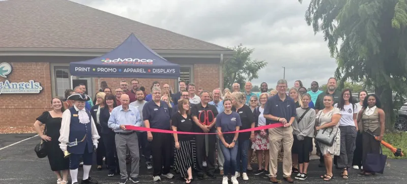 Advance Advertising cuts a ribbon
