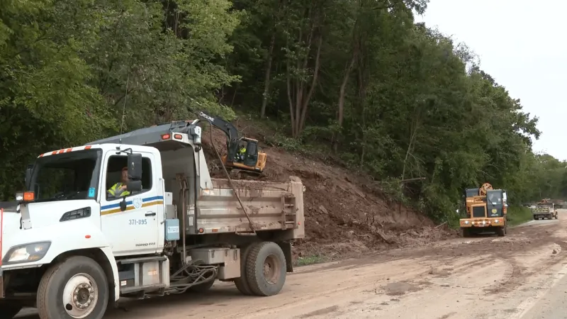 Workers cleaning up Route 2 near Sistersville following landslide