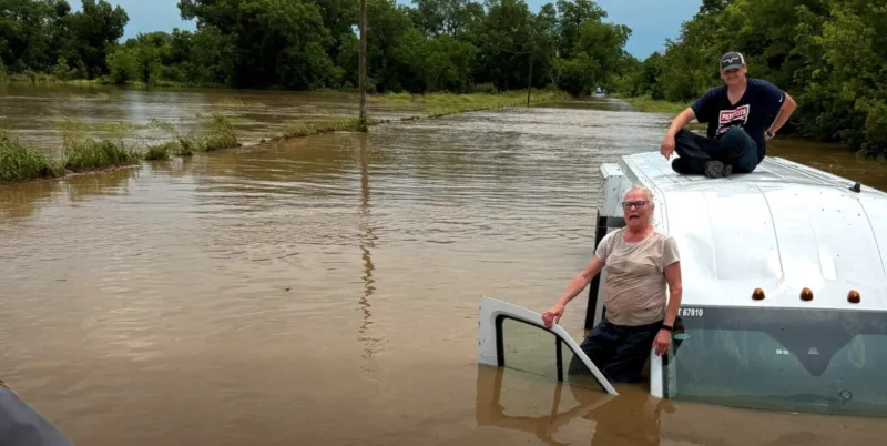 "Swift water rescue team" comes to the aid of a stranded public transit vehicle in Creek County following flash flooding