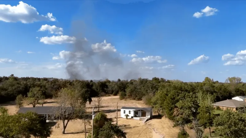 Firefighters working to contain a grass fire near S. Kermit Road north of McLoud
