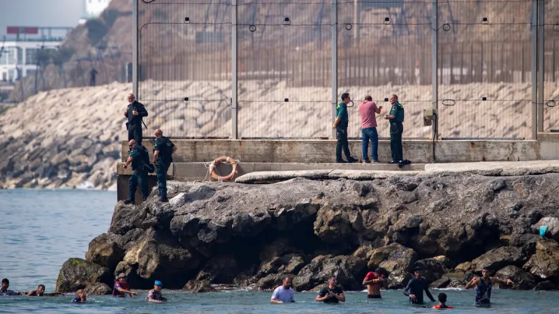 Thousands of people break through border separating Morocco from Spain's Ceuta