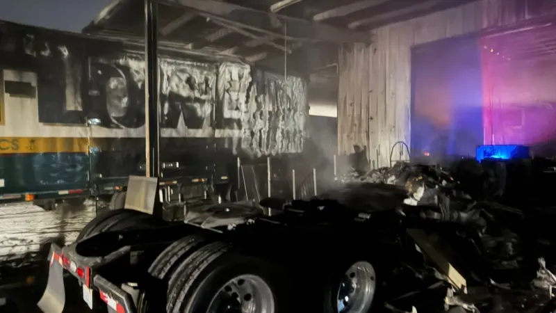 Multiple vehicles, trailer and building burn in overnight fire