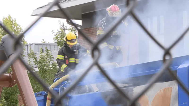Garbage truck catches fire behind school; batteries among possible causes