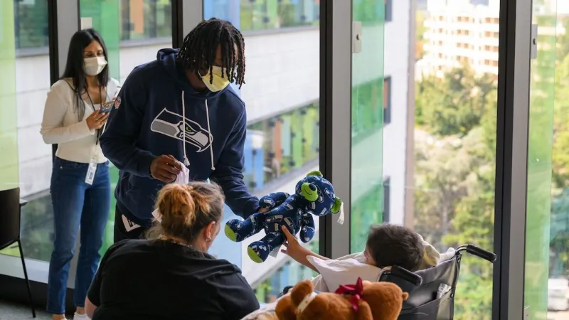 Seahawks wide receiver Rashid Shaheed brings smiles and signed swag to Seattle Children's