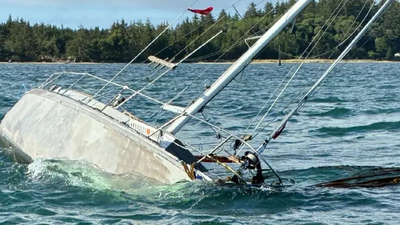 Coos County deputies, agencies remove partially submerged sailboat from Coos Bay