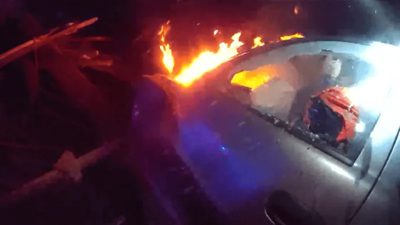 Police make dramatic rescue of fleeing 111 mph driver whose SUV crashed, caught fire