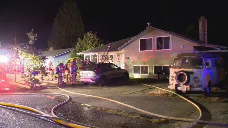 Wind-driven two alarm fire burns SE Portland home, threatens neighbor's house