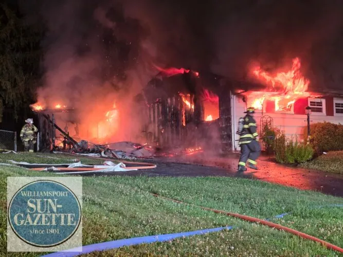 Crews battle early morning blaze as garage fire spreads to house