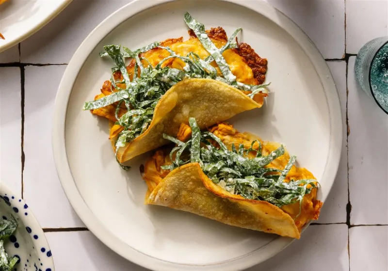 These crispy Buffalo chicken tacos come with collard slaw and ranch dressing