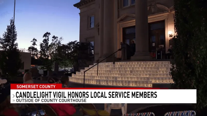 Community gathers to honor service members with candlelight vigil