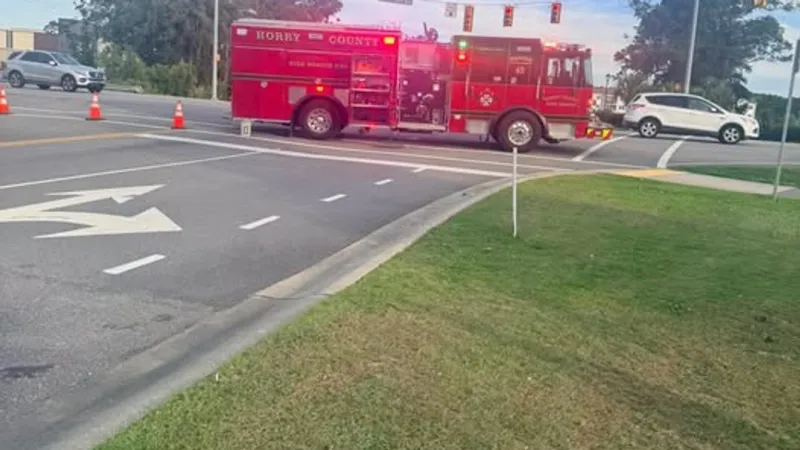 Car partially submerged in pond after crash near Carolina Forest; 2 injured