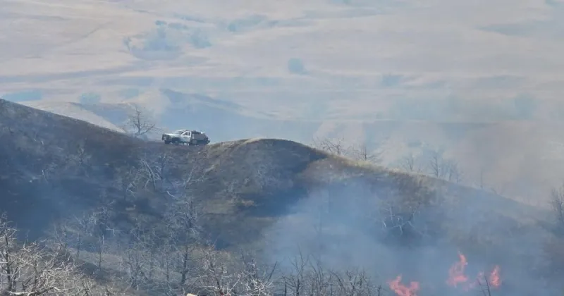 Crews continue work at large grass fire north of Wall