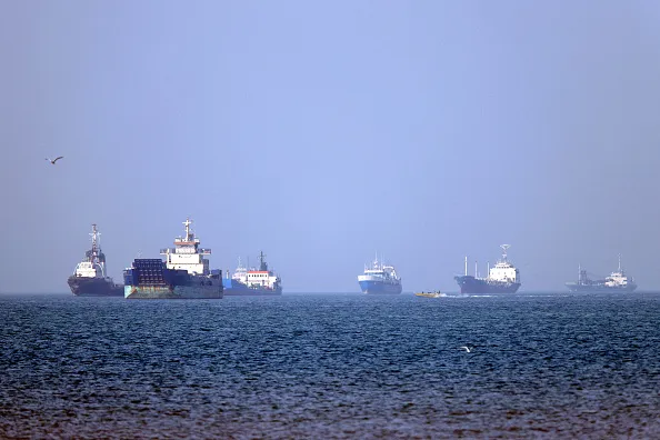 British military says a cargo ship was hit while moving through the Strait of Hormuz