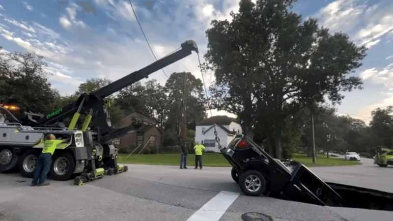 Pickup truck swallowed after broken water main triggers massive 20-foot sinkhole