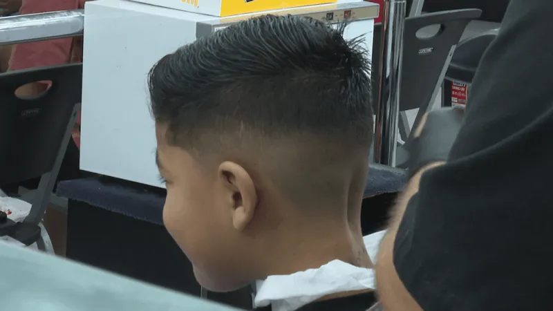 Free haircuts, backpacks, and food: Barbershop helps kids head back to school in style