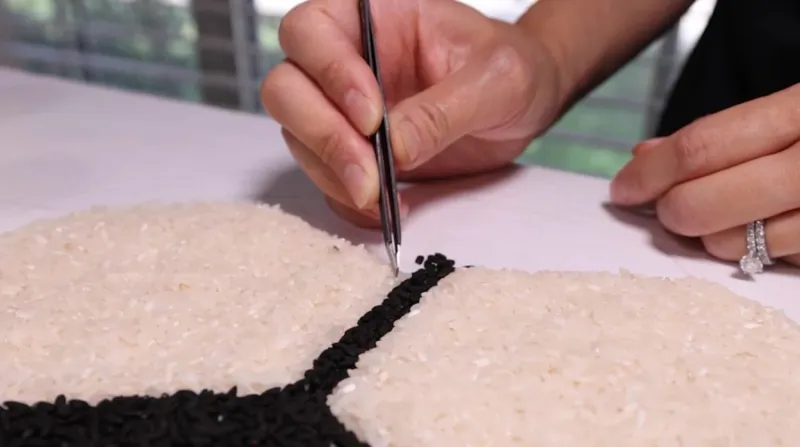 Toss up: Flower Mound artist's rice portraits last a split second, but captivate millions