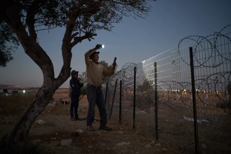 A flashlight and unseen settlers: Photographer conveys West Bank family's nightly watch in 1 photo