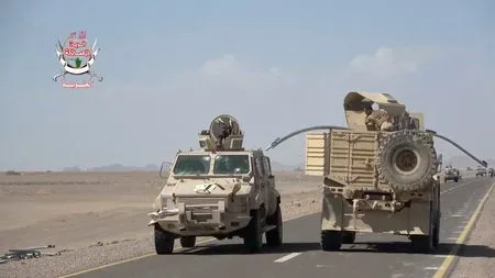 Yemeni government fighters recorded driving vehicles over Houthi opponents