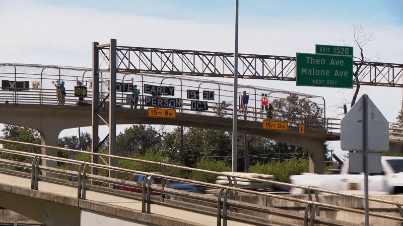 GALLERY: 'No Kings' activists drape San Antonio bridges to rally early voters