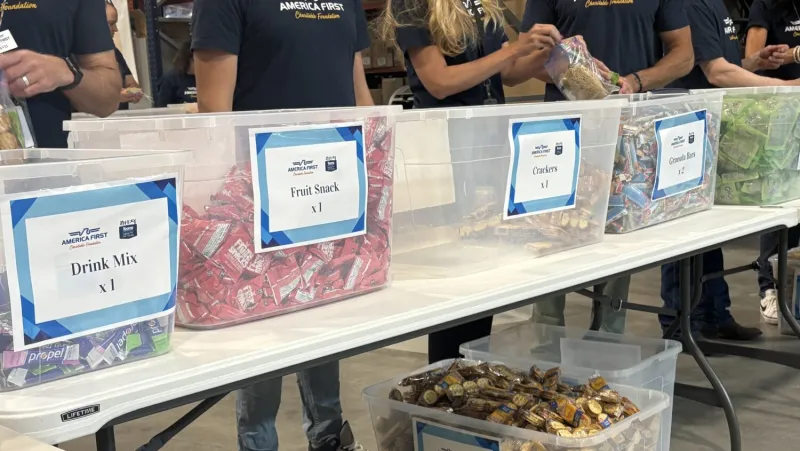 Volunteers from 2 Utah companies help pack thousands of meal kits for students in need