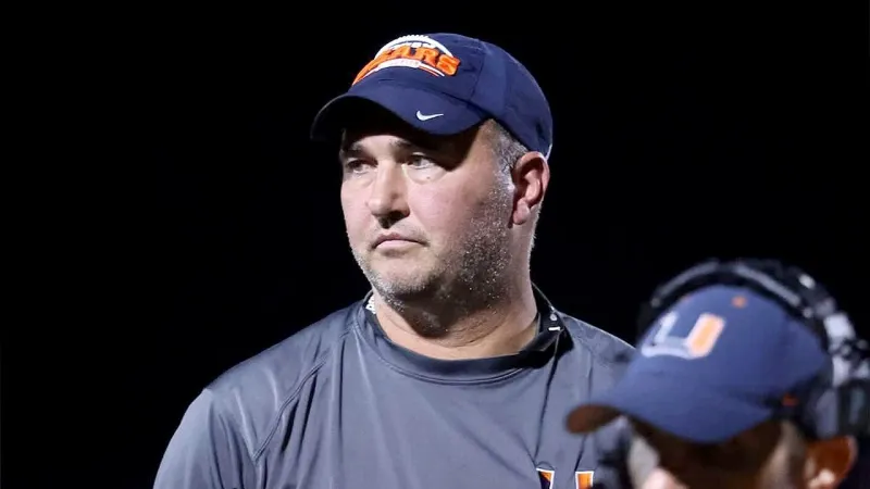 Fugitive football coach disappeared into woods with gun, family says
