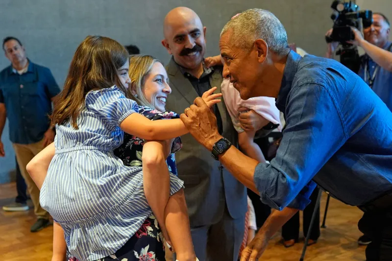 Barack and Michelle Obama surprise first visitors to newly opened presidential center