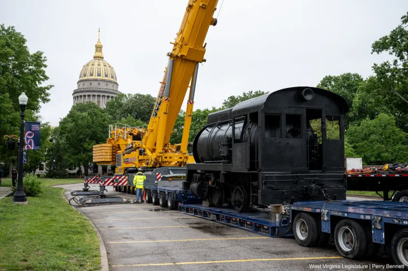 50-ton steam engine, 20-ton coal shuttle car placed beside state Culture Center for America 250 celebration