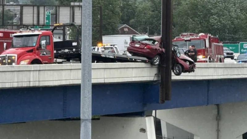 Charleston crash leaves vehicle dangling from interstate bridge