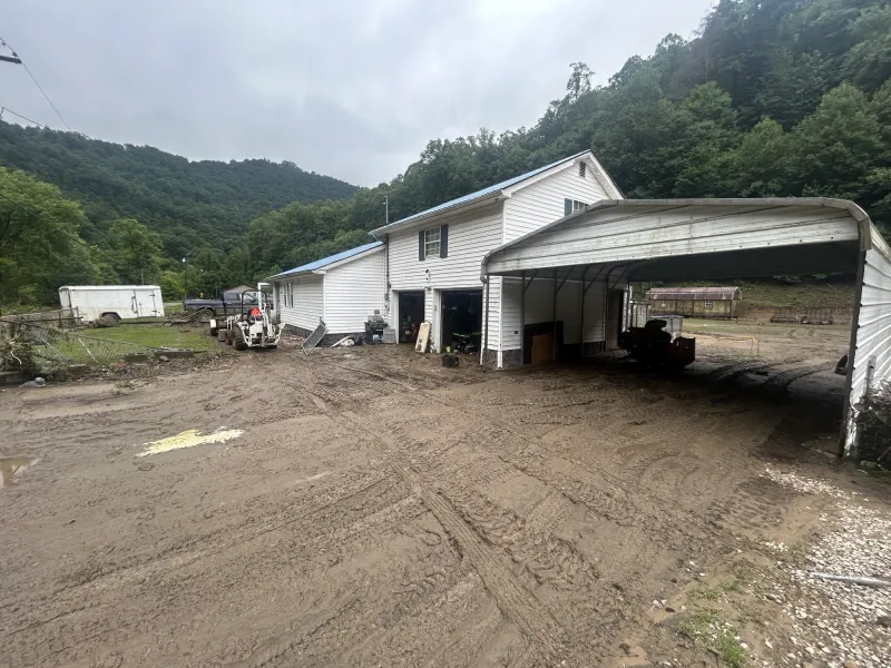 Flooding along Pond Fork leaves a long trail of mud and damage along Route 85 in Boone County