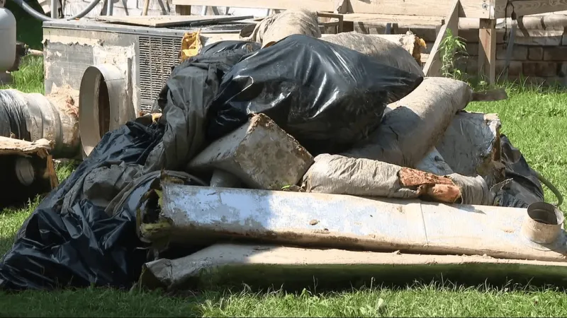 Volunteers help clean flood-damaged homes one week after flooding hits Boone