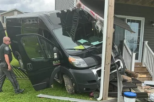 Vehicle Rolls from Residential Parking Area and Runs into Neighboring Home; Van, Residence See Damage