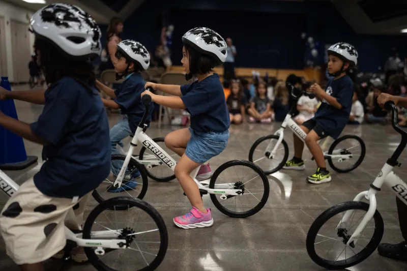 A childhood rite moves indoors as kindergartners learn to ride bikes in school gyms