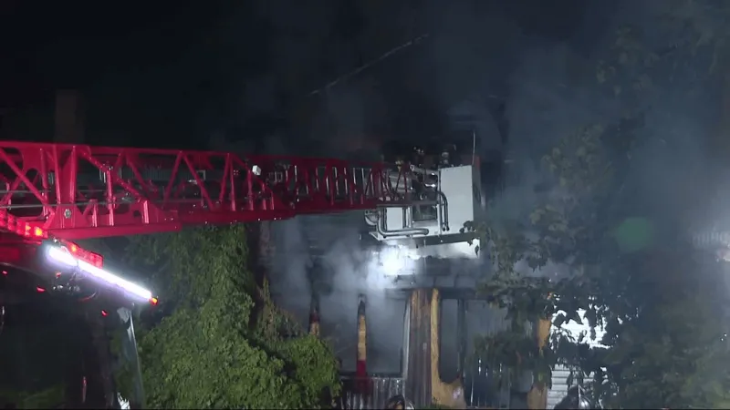 Fire rips through boarded-up West Side home, threatens nearby church property