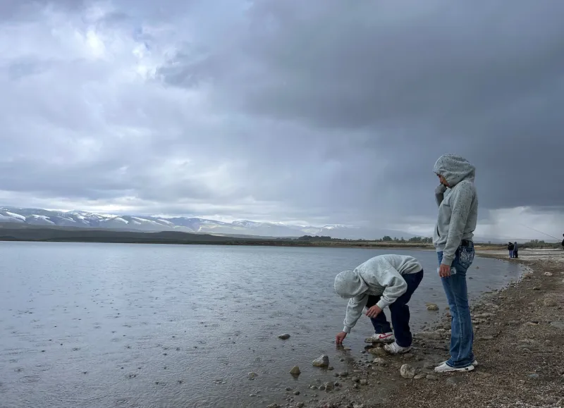 Tribal students in central Wyoming release small fish in a big pond