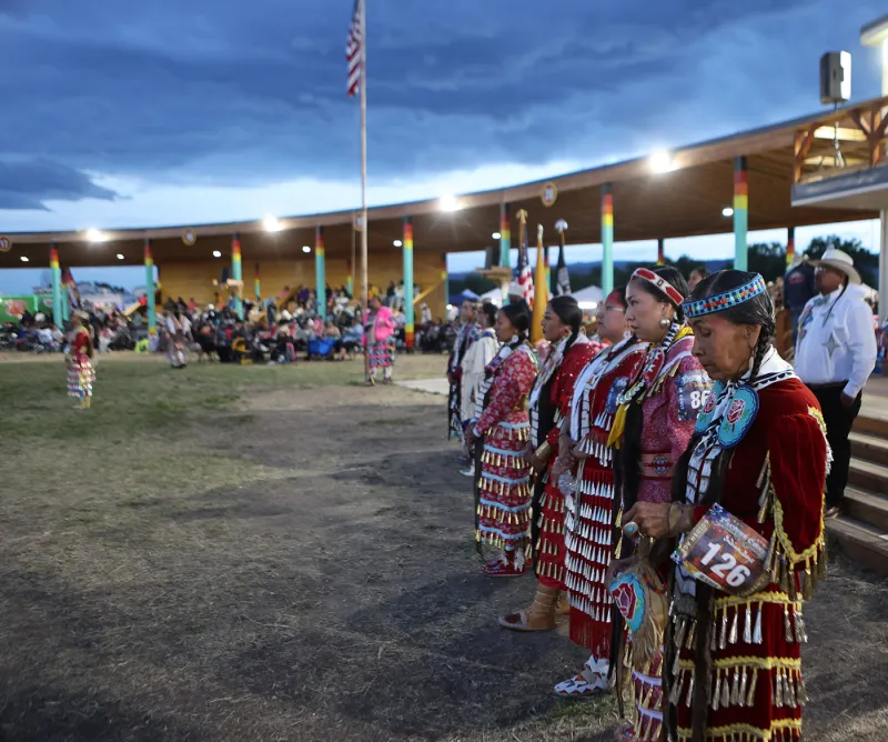 Dancers at Wind River powwow don red regalia to honor grieving families