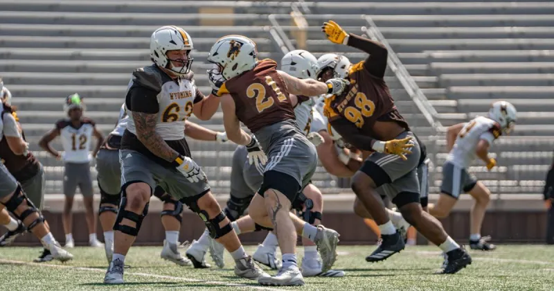 Wyoming's fall camp opens with a major line shakeup, and a new quarterback battle emerges